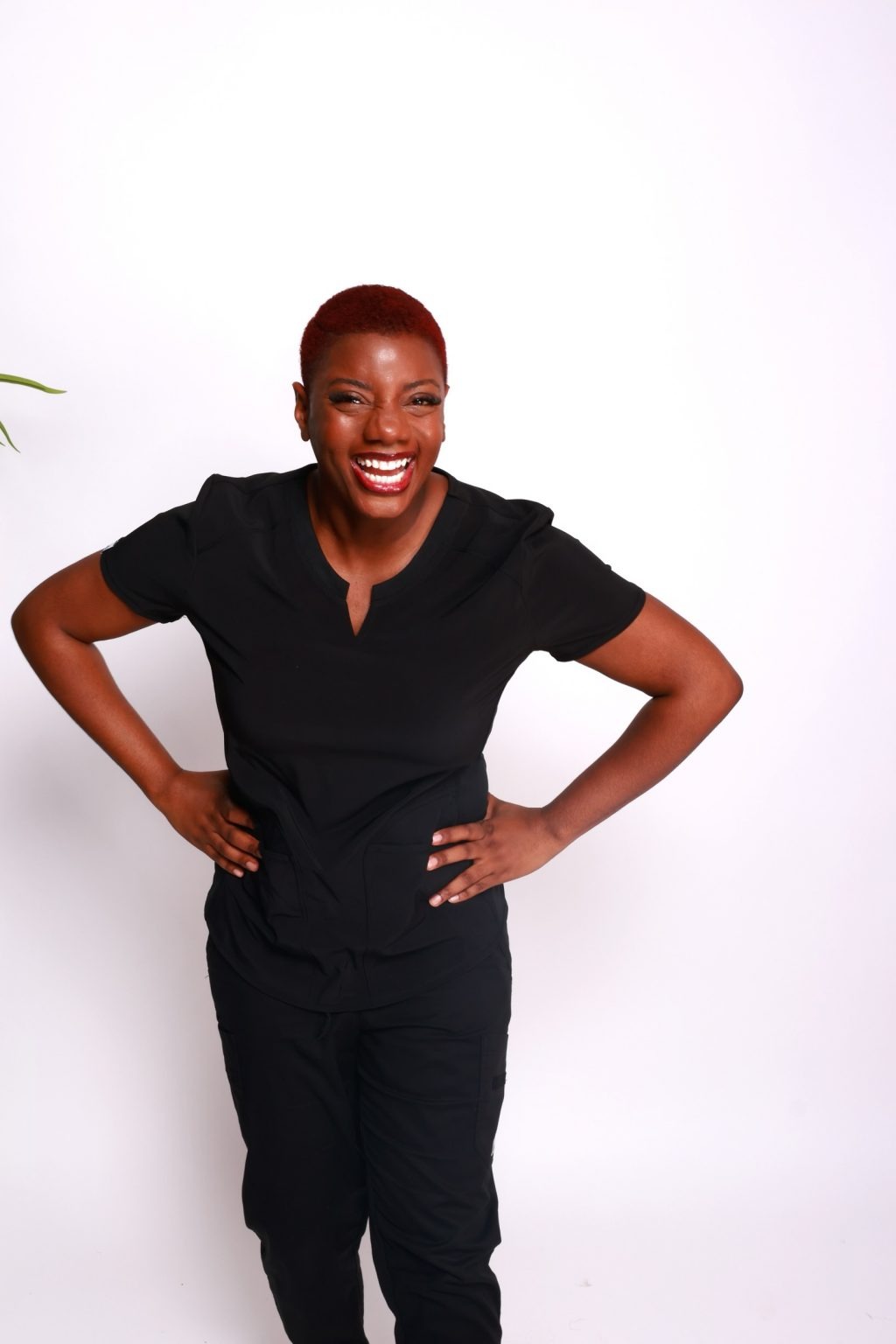Whitney Johnson, owner of The Bella Lucy Spa, smiling in black scrubs